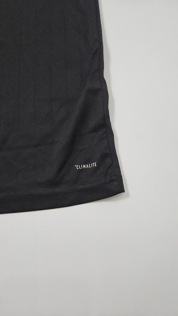 Adidas Climalite Black T-shirt (Category: Shirts) located in Alfonso. Submitted by jbcamet (Listing ID 1469861866, Image 3). Description: - Authentic Adidas youth sports t-shirt in black - Size 140 (Youth sizing) - Climalite fabric technology wicks away sweat to keep you dry during training - Features contrasting white v-neck collar and signature shoulder stripes - Small printed Adidas logo on the chest - Made in Cambodia - Perfect for school spo