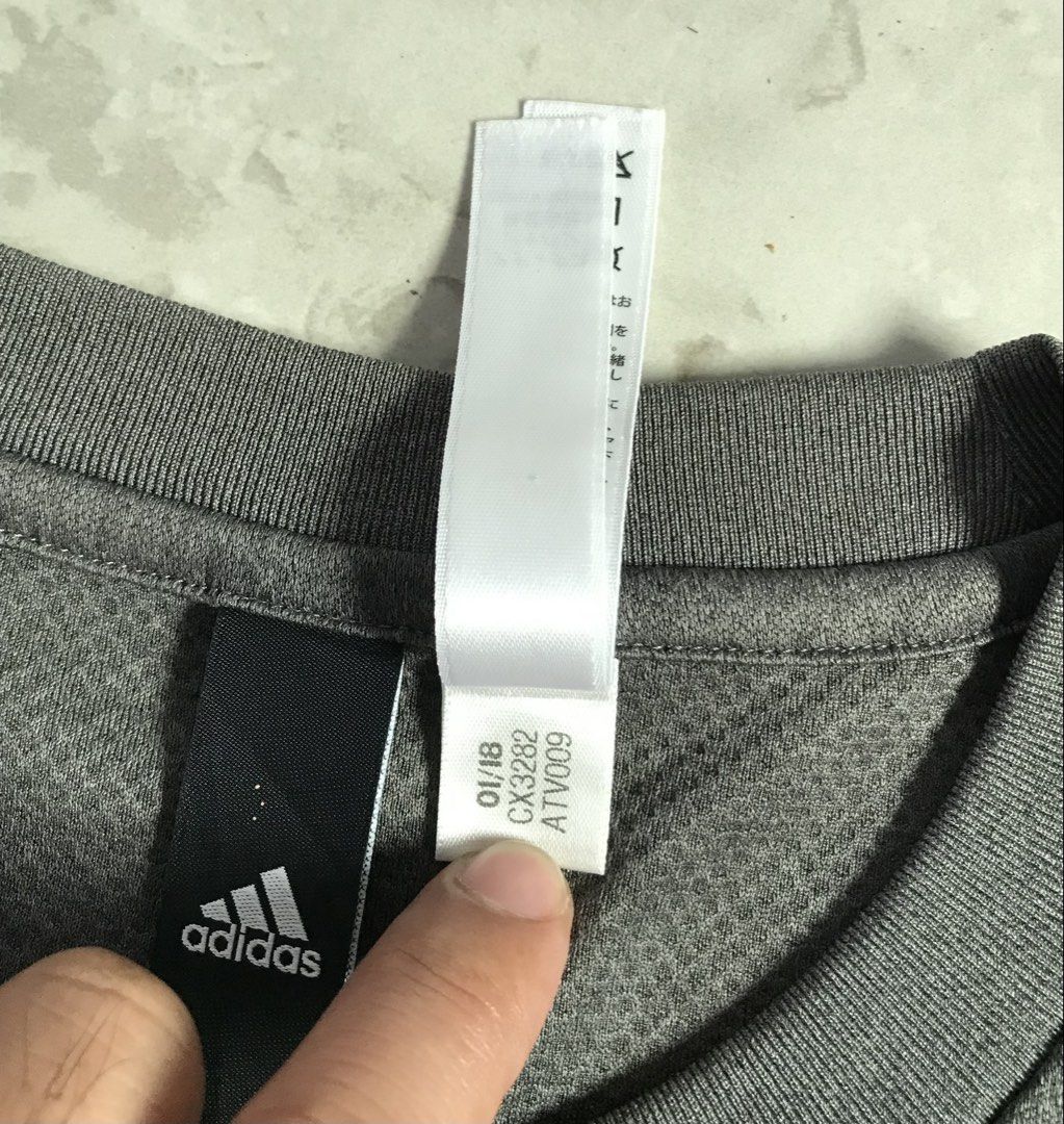 Adidas Grey Athletic T-Shirt Size L (Category: Tshirts & Polo Shirts ) located in Banga. Submitted by brighthorse.b8f582 (Listing ID 1469868077, Image 2). Description: - Brand: Adidas - Color: Grey with large black graphic logo - Size: L (Product Code: CX3282) - Material: 100% breathable polyester - Condition/Details: Short sleeves, crew neck, manufactured 01/18 - Best for: Gym workouts, running, or casual streetwear - PM for inquiries or fast sh