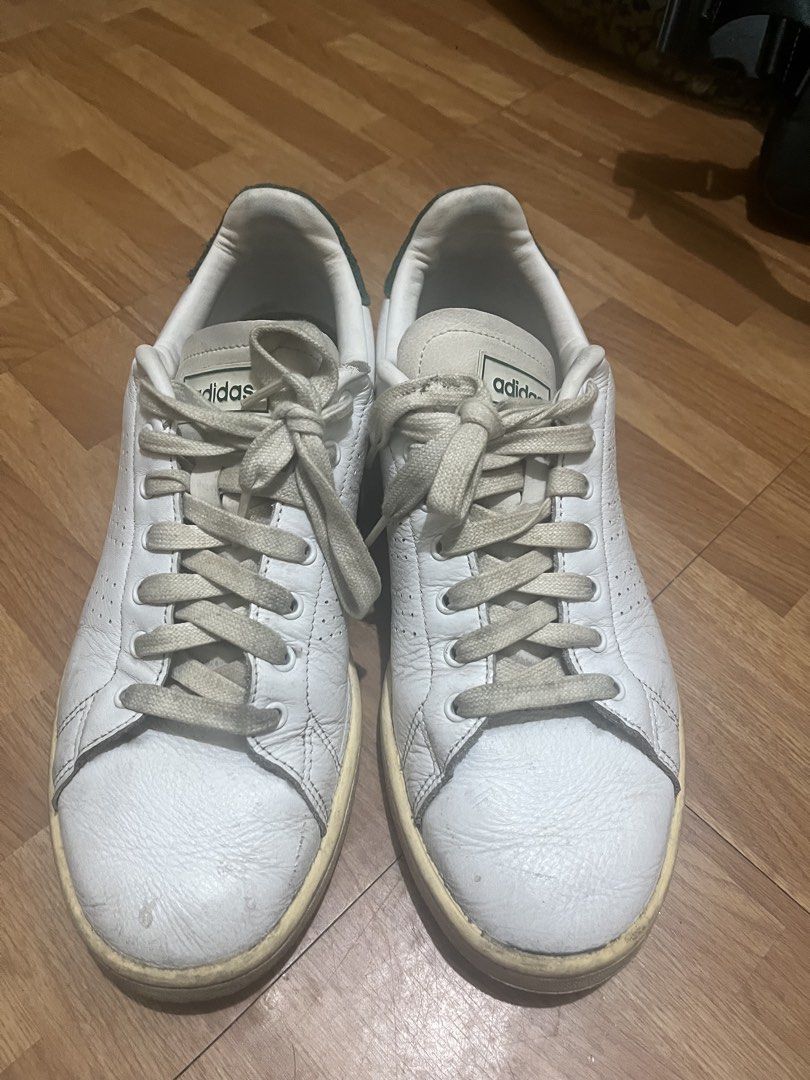 Adidas Stan Smith White Green Sneakers (Category: Casual Shoes) located in Makati City. Submitted by turonevo (Listing ID 1469827236, Image 1). Description: - Color/Material: White leather with green suede heel tabs - Details: Classic branding on the tongues, laces included - Condition: Visible yellowing on soles from age and use, scuffs on leather uppers and toe areas - Durability: Tread is still fully intact - Fit/Style: Great casual everyday p