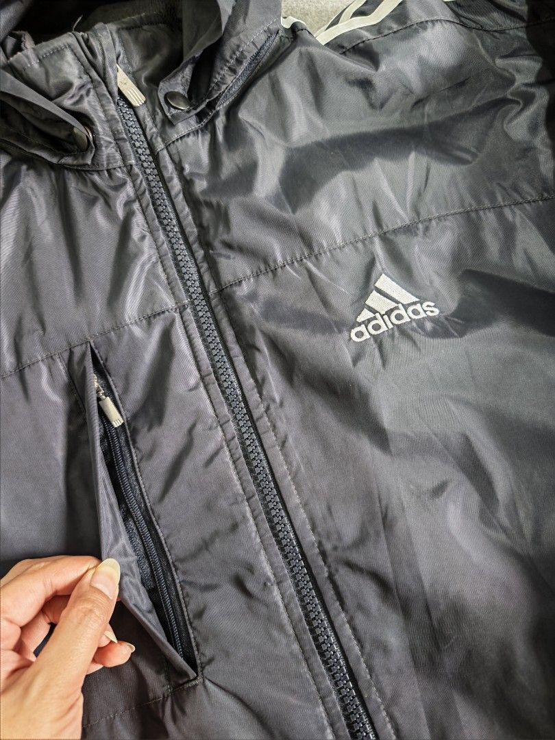 Adidas Winter Puffer Jacket (Category: Coats, Jackets and Outerwear) located in Manila. Submitted by goku_doggo (Listing ID 1469839925, Image 2). Description: - Authentic vintage 2003 Adidas padded jacket - Color: Classic Navy Blue with white three stripes on sleeves - Features: Full zip closure, high collar, and attached hood for maximum warmth - Storage: Secure side zippered pockets - Condition: Well-maintained, rare find from 2003 - Perfect fo