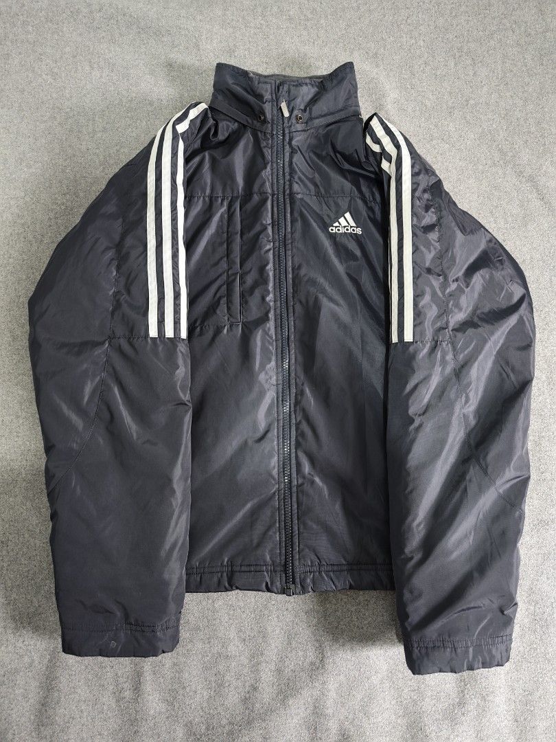 Adidas Winter Puffer Jacket (Category: Coats, Jackets and Outerwear) located in Manila. Submitted by goku_doggo (Listing ID 1469839925, Image 3). Description: - Authentic vintage 2003 Adidas padded jacket - Color: Classic Navy Blue with white three stripes on sleeves - Features: Full zip closure, high collar, and attached hood for maximum warmth - Storage: Secure side zippered pockets - Condition: Well-maintained, rare find from 2003 - Perfect fo