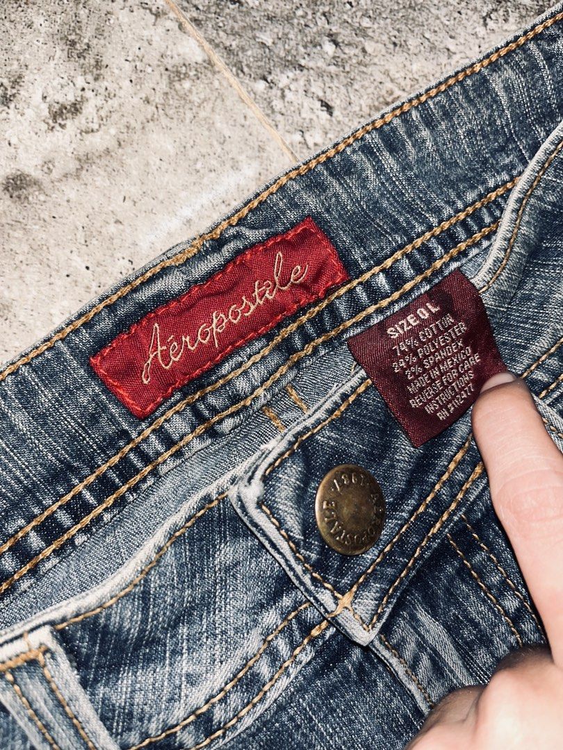 Aeropostale Flare Jeans Size 0L (Category: Jeans) located in Dagupan City. Submitted by shanadongsb (Listing ID 1469864373, Image 3). Description: - Brand/Style: Aeropostale low-rise flare jeans - Wash/Color: Medium wash denim with contrast stitching - Size: 0L (Long) - Details: Front flap pockets and button-flap back pockets - Material: Cotton, polyester, and spandex blend - Condition: Slight distressing along the bottom hems from regular wear.