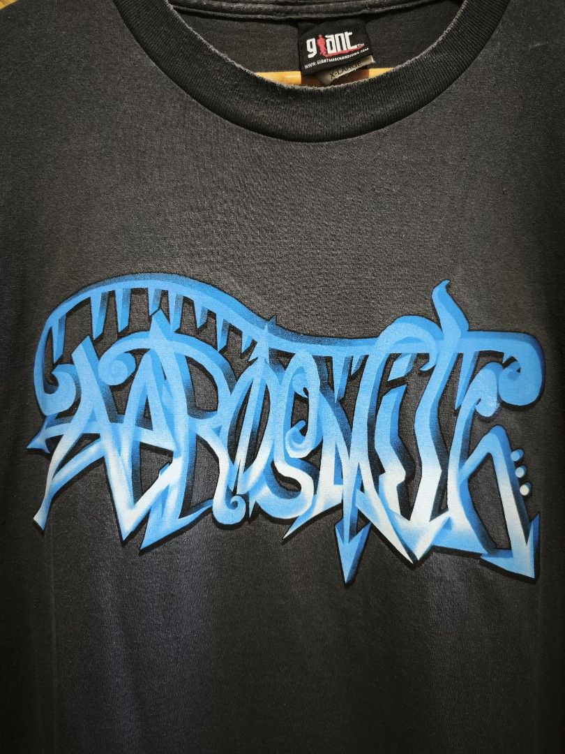 Aerosmith Graffiti Y2k Shirt (Category: Tshirts & Polo Shirts ) located in Candon. Submitted by ylocos_thrifts (Listing ID 1469845656, Image 2). Description: Aerosmith Graffiti Y2k 90's Giant Tag Made in USA Size: XL Dimension: Length - 30 Width- 23.5 Good Condition Issue: Small loose stitch & unreadable na ung dated.