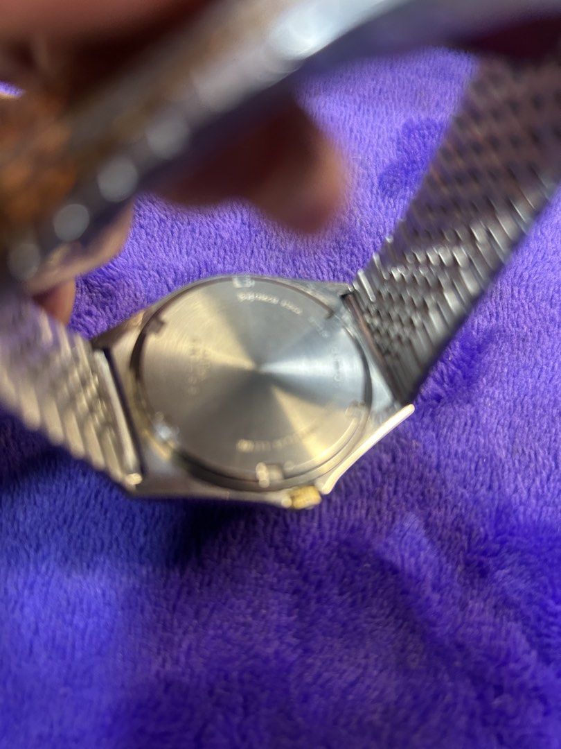 Alba Quartz Two-Tone Men's Watch (Category: Men's Watches) located in Cavite. Submitted by mamamia73 (Listing ID 1469902475, Image 3). Description: Alba quartz watch with a two-tone silver and gold bracelet. Cream dial featuring day and date display at the three o'clock position. Water resistant up to ten bars. Signed clasp with Alba branding. Shows scratches on the crystal and minor wear on the case and band. Standard deployment clasp closure..