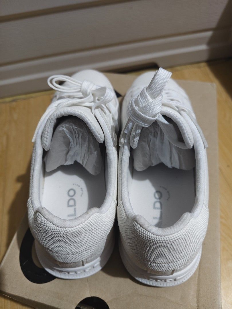 ALDO Jeremie White Sneakers (Category: Sneakers) located in San Juan City. Submitted by jzurc19 (Listing ID 1469840059, Image 3). Description: - Brand: ALDO (Model: Jeremie) - Color: Classic White - Condition: Brand new, 100% spotless outsoles, never worn outside - Material: Clean white leather upper with textured heel panel - Details: Embossed logo on the midsole - Inclusion: Comes with original shoe box and internal paper stuffing - Rationale f