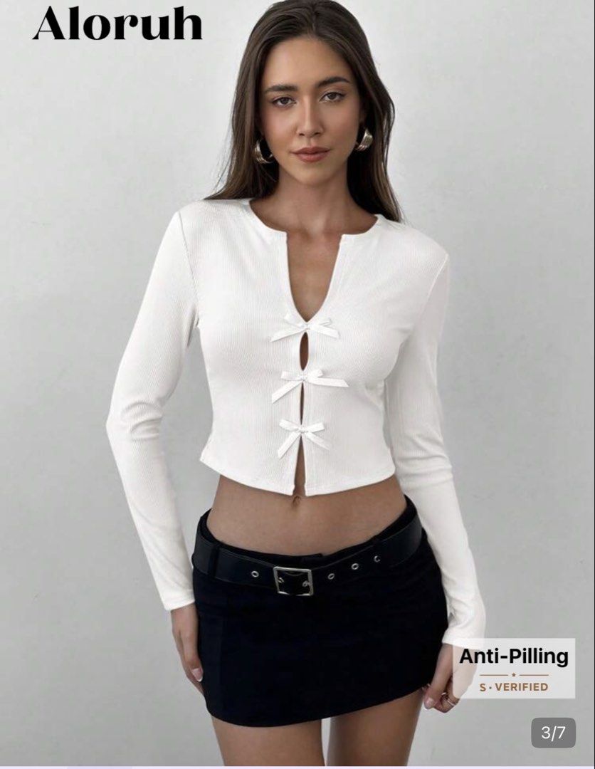 Aloruh White Ribbed Bow Top (Category: Longsleeves) located in Manila. Submitted by cole0702 (Listing ID 1469894862, Image 2). Description: * Please manage expectations (this is not brand new) * Color may slightly vary due to lighting. * No return, refund, or exchange. * Kindly check all photos before purchasing. * SFs/DFs: Shouldered by the client - Style: Fitted, cropped length long sleeve top - Details: Deep neckline with 3 front bow closures 