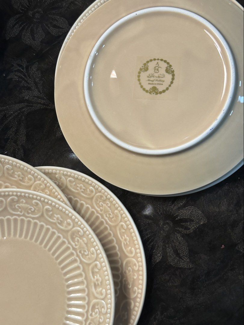 Alsaif Gallery Beige Decorative Saucers/Platito Set (Category: Dinnerware & Cutlery) located in Manila. Submitted by tenshiii185 (Listing ID 1466913901, Image 2). Description: - Brand: Alsaif Gallery - Color: Soft beige tone - Design: Intricate embossed scroll and fluted border with a smooth glossy center - Origin: Made in China - Condition: Matching set, stacked neatly - Best for: Elegant dining table setup or kitchen display.