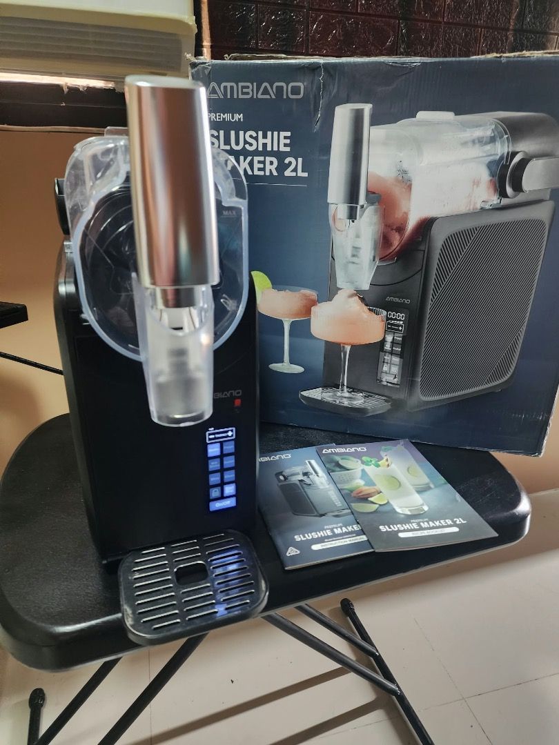 Ambiano Premium Slushie Maker 2L (Category: Juicers, Blenders & Grinders) located in Pulilan. Submitted by sebbii (Listing ID 1469791839, Image 2). Description: - Brand: Ambiano Premium Slushie Maker - Capacity: 2 Liters - Color: Sleek black finish with elegant silver dispenser handle and control panel - Inclusions: Complete with original box, user manual, and recipe booklet - Condition: Extremely clean, well-maintained, and ready for use - Perfe