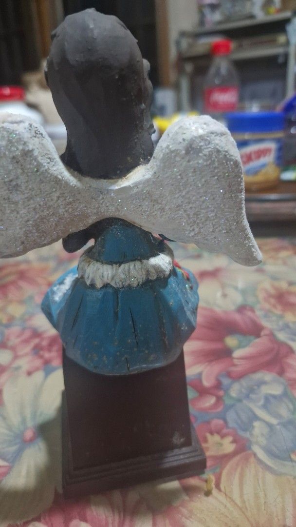 Angel figurine Only (Category: Figurines & Statues) located in Quezon City. Submitted by belikabim2014 (Listing ID 1469929380, Image 3). Description: - Angel figurine holding a small book - Blue dress with fuzzy white trim and painted red floral design - Glittery white wings on the back -8 inches long - Dangling red cloth pants with brown boots - Dark hair styled with a crown detail - display block not included.