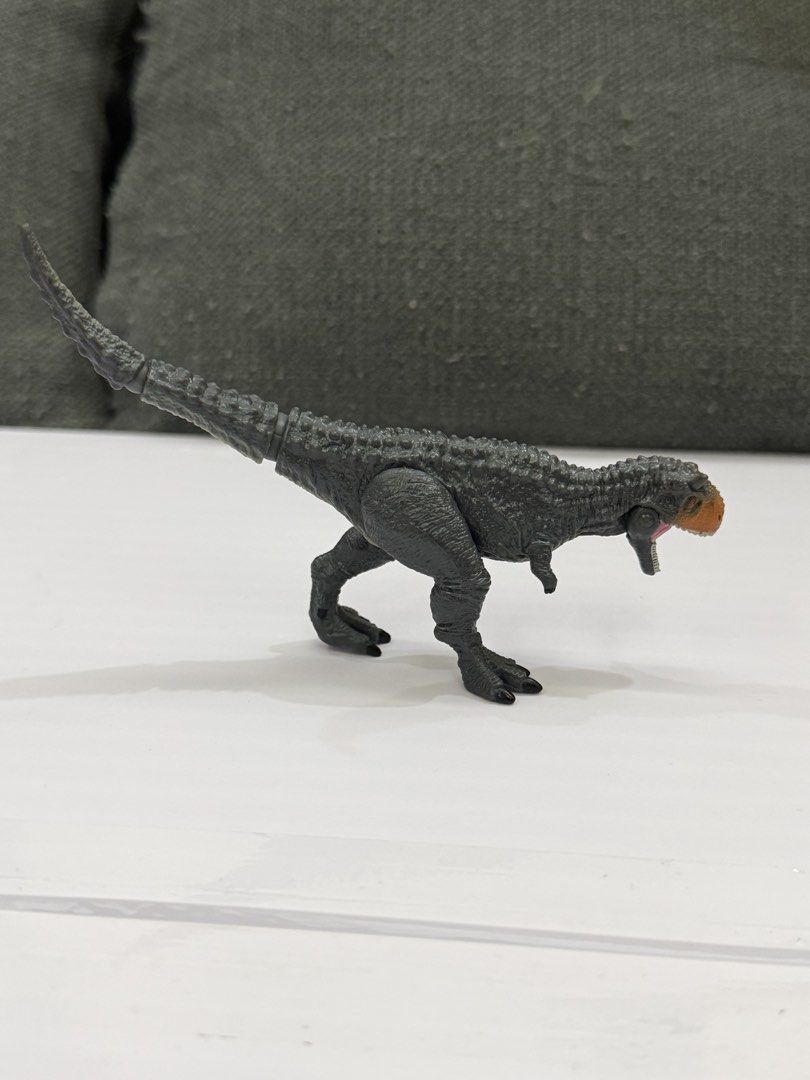 Ania Jurassic World Carnotaurus (Category: Action & Battle Toys) located in Lipa City. Submitted by cokelight11 (Listing ID 1469901287, Image 3). Description: Authentic Ania Jurassic World Carnotaurus Bring adventure to life with the Takara Tomy Ania Jurassic World Carnotaurus, featuring a striking gray body with a vivid orange and black head. Fully articulated tail, movable legs, and hinged jaw that opens wide. Stands firmly on its own for displ