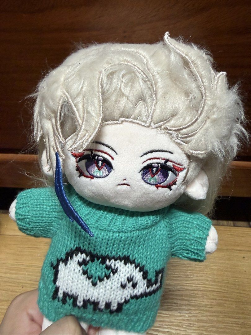 20cm Neuvillette w/ Skeleton (Category: Plushies & Soft Toys) located in Manila. Submitted by mysticmoon.bc808c (Listing ID 1469869200, Image 1). Description: Plush doll featuring embroidered purple eyes and stylized white hair. Wears a turquoise knitted sweater decorated with a white animal graphic. Long hair flows down the back. Soft fabric construction, well-suited for collectors or fans of character merchandise..
