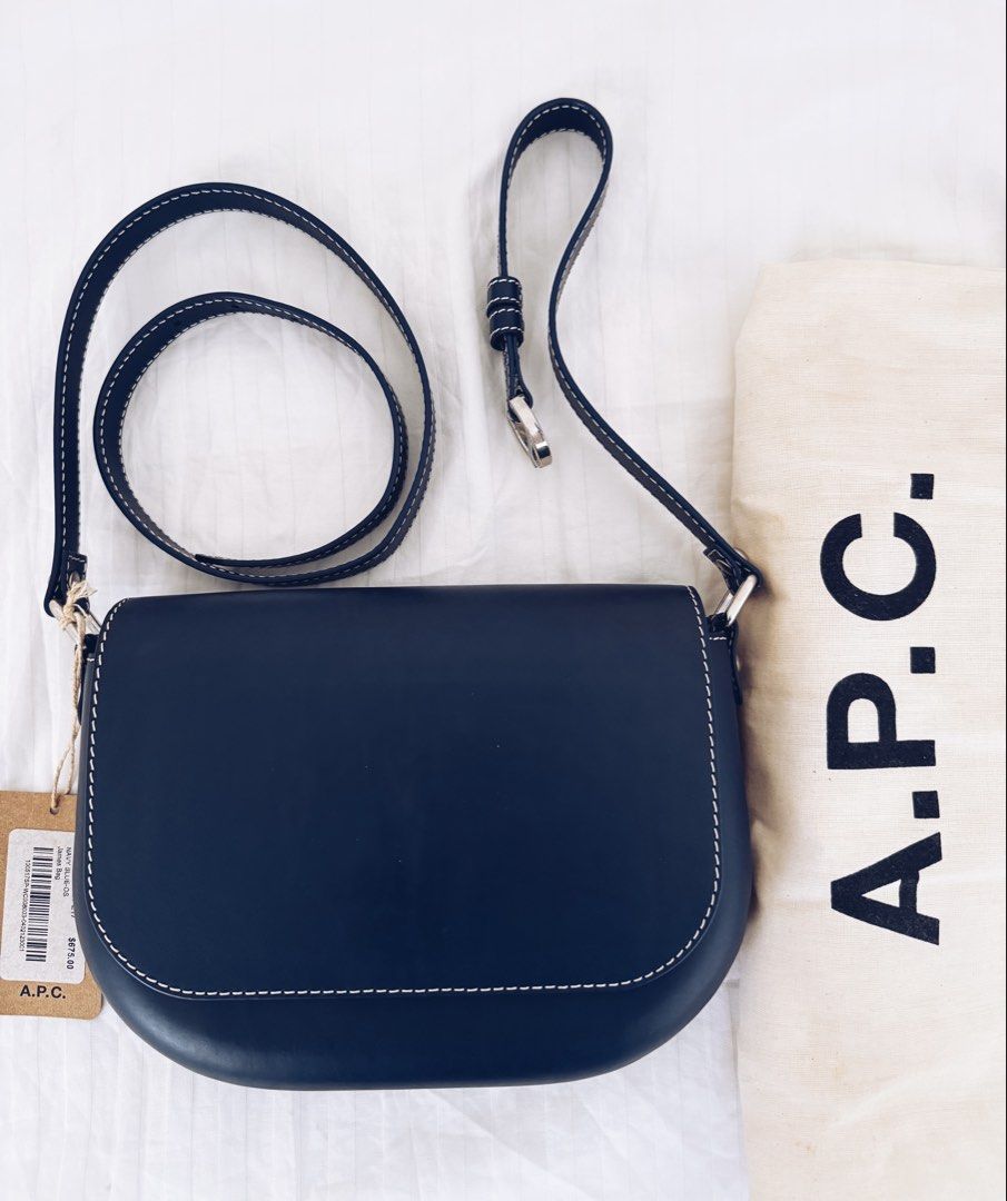 A.P.C. James Crossbody Bag (Category: Cross-body Bags) located in Paranaque City. Submitted by nuitnoirnoe (Listing ID 1469765450, Image 3). Description: - Brand: A.P.C. - Color: Navy blue leather with natural tan interior - Details: Chic white contrast stitching and sleek silver hardware - Included: Adjustable shoulder strap, original dust bag, and store tag - Condition: Brand new with tags (Retails at $675) - Negotiable for serious buyers.