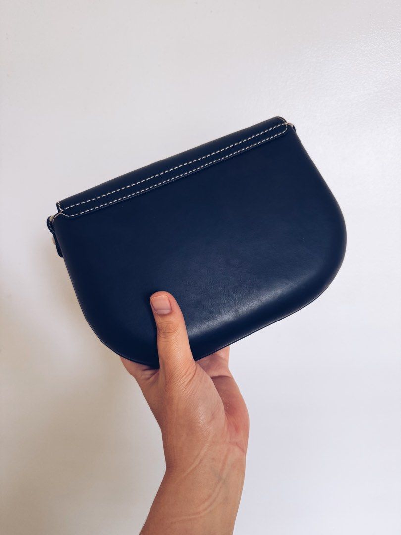 A.P.C. James Crossbody Bag (Category: Cross-body Bags) located in Paranaque City. Submitted by nuitnoirnoe (Listing ID 1469765450, Image 2). Description: - Brand: A.P.C. - Color: Navy blue leather with natural tan interior - Details: Chic white contrast stitching and sleek silver hardware - Included: Adjustable shoulder strap, original dust bag, and store tag - Condition: Brand new with tags (Retails at $675) - Negotiable for serious buyers.