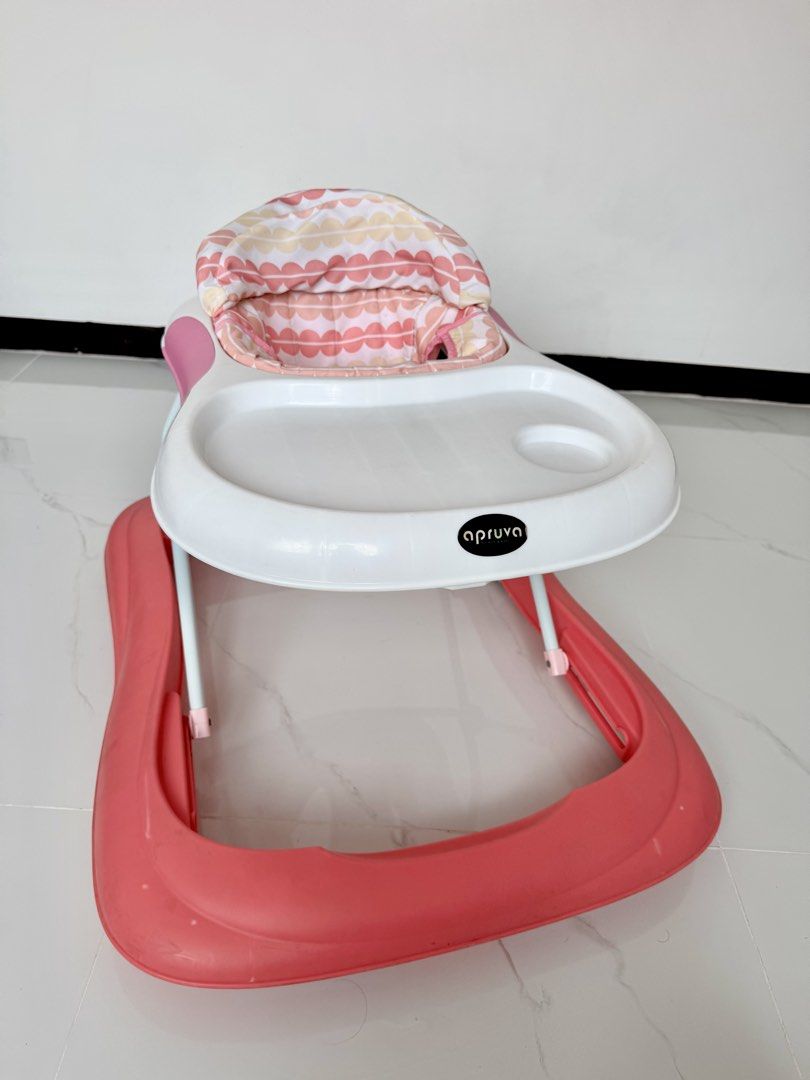 Apruva Pink Baby Walker (Category: Infant Playtime) located in Las Pinas. Submitted by lykarabino (Listing ID 1469808764, Image 2). Description: ‼️Apruva Baby Walker‼️ - Brand: Apruva - Color: Pink and white with pastel patterned seat - Design: Sturdy frame with a wide base for maximum stability - Mobility: Smooth-rolling wheels and convenient back push handle - Features: Built-in activity tray with a cup holder slot - Condition: Clean, comfortab