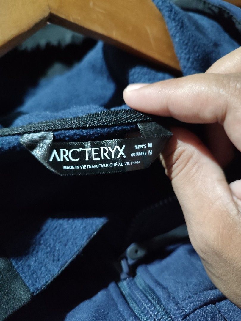 Arc'teryx Navy Hooded Jacket Men's Medium (Category: Coats, Jackets and Outerwear) located in Puerto Princesa. Submitted by thriftedsoulsy2k (Listing ID 1469902408, Image 3). Description: - Brand: Arc'teryx - Color: Navy Blue - Size: Men's Medium - Material: Comfortable softshell fabric - Features: Full zip front, dual chest pockets, lower hand pockets, and adjustable hood with drawcords - Details: Clean embroidered chest logo and branded zipper 