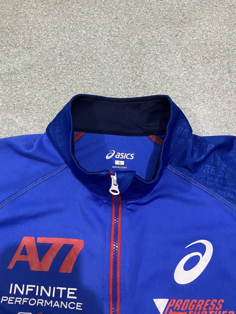 Asics A77 Infinite Performance Track Jacket Blue Size S (Category: Coats, Jackets and Outerwear) located in Baguio. Submitted by chicoroy (Listing ID 1469908983, Image 2). Description: - Brand: Asics A77 - Item: Athletic Track Jacket - Color: Royal Blue with Red Zipper Track - Size: S (tag at collar) Dimes:19.5/25 Ukay source need wash - Features: Quarter-zip closure, printed graphics on chest and sleeves ("PROGRESS FURTHER", "TRANSMISSION"), con