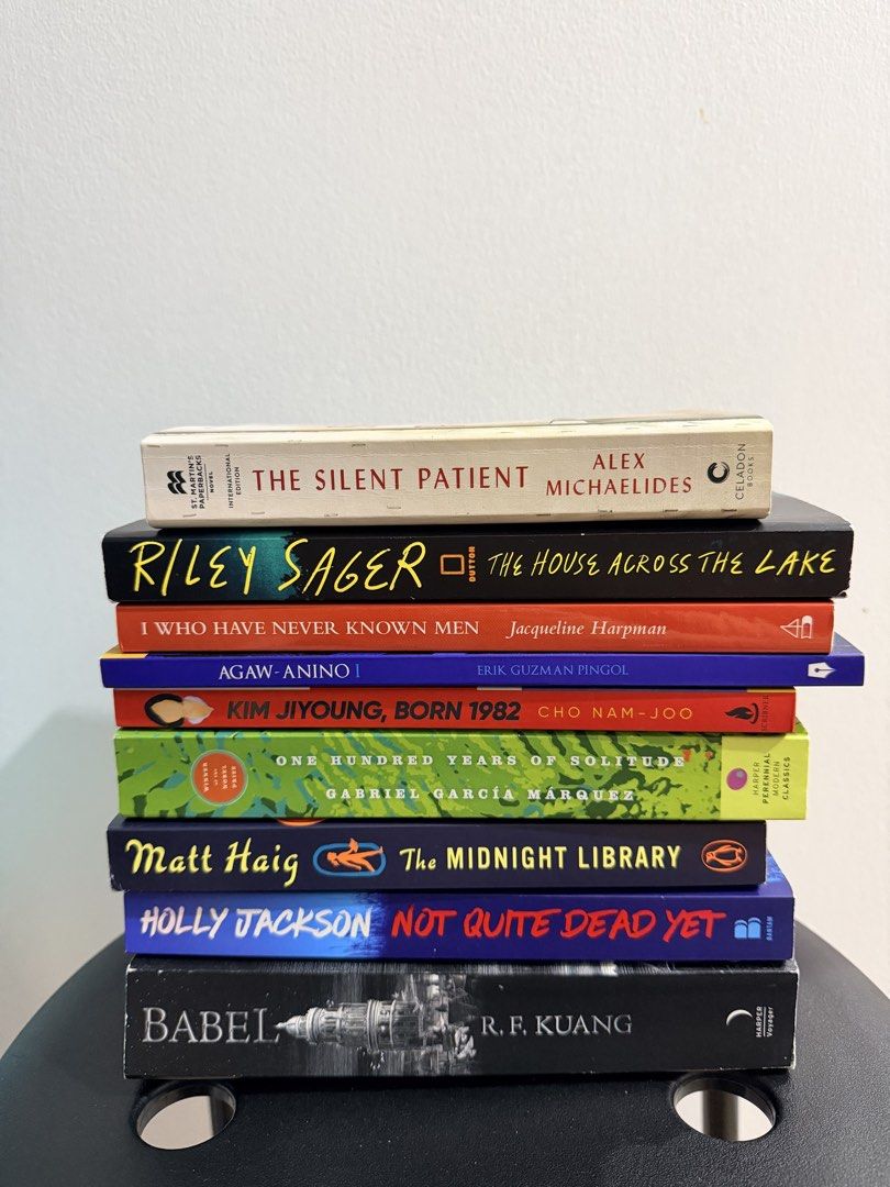 Assorted Fiction and Thriller Novels Stack (Category: Storybooks) located in Manila. Submitted by everyday_store (Listing ID 1469891859, Image 2). Description: - Set of 9 popular fiction and thriller paperbacks - Includes: The Silent Patient, The House Across The Lake, Babel, The Midnight Library, and One Hundred Years of Solitude - Authors: Alex Michaelides, Riley Sager, R.F. Kuang, Matt Haig, and Gabriel Garcia Marquez - Condition: Read once, s