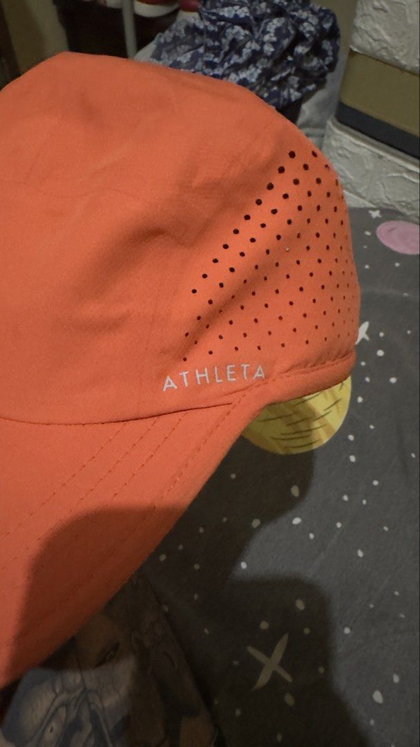 Athleta Orange Running Hat One Size Lightweight Ventilated Reflective (Category: Hats & Beanies) located in Plaridel. Submitted by estanislao.noveno (Listing ID 1469790187, Image 2). Description: - Brand: Athleta - Color: Bright orange - Size: One size fits all with an adjustable bungee cord at the back - Material: Lightweight polyester with laser-cut ventilation holes - Features: Subtle reflective logo near the brim - Care: Easy to wash, perfect