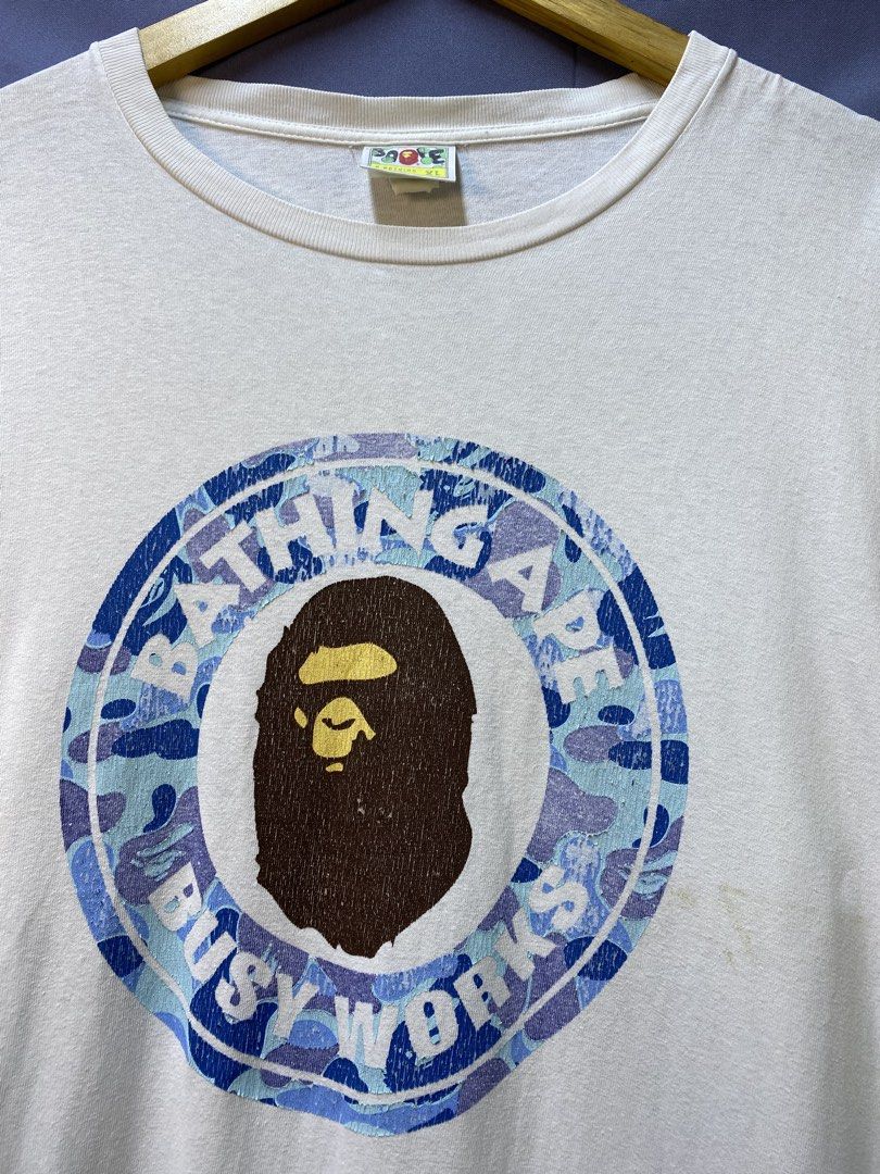 AUTHENTIC BAPE “BUSY WORKS” (Category: Tshirts & Polo Shirts ) located in Makati City. Submitted by drip.poww (Listing ID 1469822762, Image 3). Description: - Authentic Bape - Color: white - Size: XL - Dimes: 24x30 - Authentic - Hairlines / Cracks - Excellent condition - Need wash, fresh from bale - Material: 100% Cotton Please don’t expect too much—these are thrifted (ukay) items. 😊 !!STILL NEGOTIABLE!!.