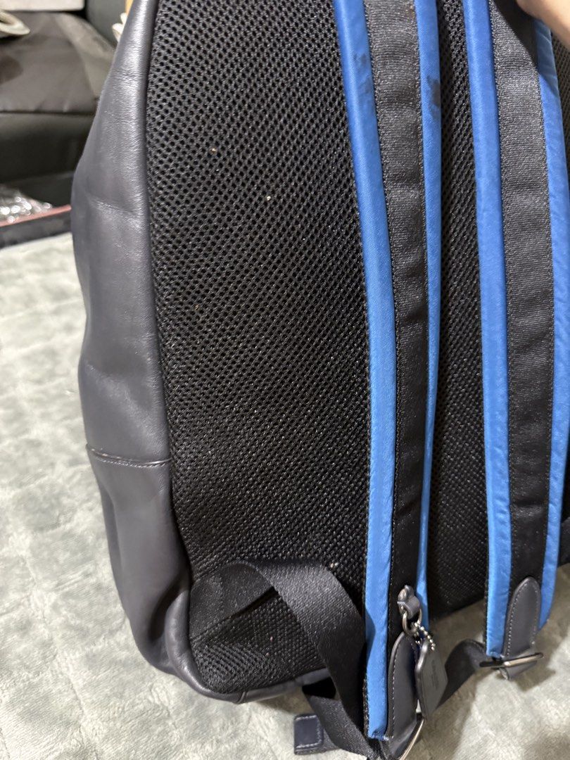 Authentic Coach New York Blue and Grey Leather Backpack (Category: Backpacks) located in Quezon City. Submitted by vianca13 (Listing ID 1469818474, Image 3). Description: - Authentic Coach New York backpack - Color: Blue nylon with dark grey leather bottom and front pocket - Large embroidered Coach logo on the front - Breathable black mesh back panel with adjustable padded straps - Black fabric interior lining with zippered pocket and leather cre