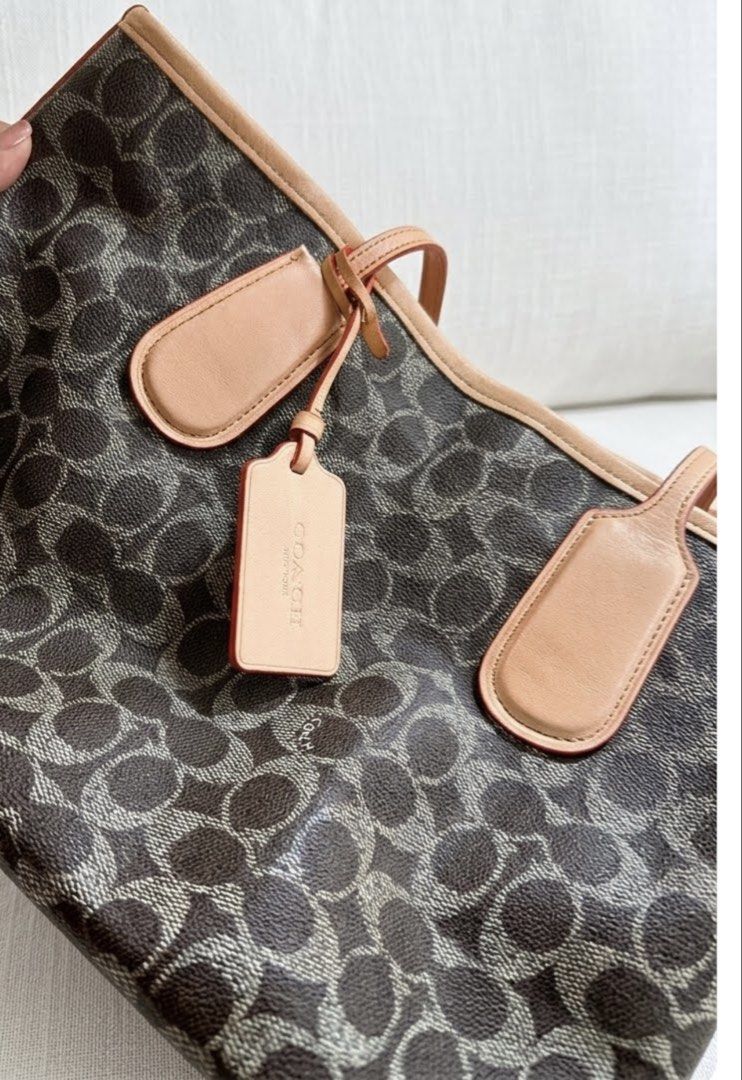 Authentic coach small city zip tote (Category: Tote Bags) located in Caloocan City. Submitted by trebdy01 (Listing ID 1469940923, Image 2). Description: 100% Authentic Coach Small City Zip Tote in Signature Canvas (Dark Brown / Vachetta Trim) Description: Selling an authentic Coach Small City Zip Tote Bag in classic dark brown signature coated canvas with smooth vachetta/tan leather trim. This is the perfect lightweight daily shoulder bag—not too