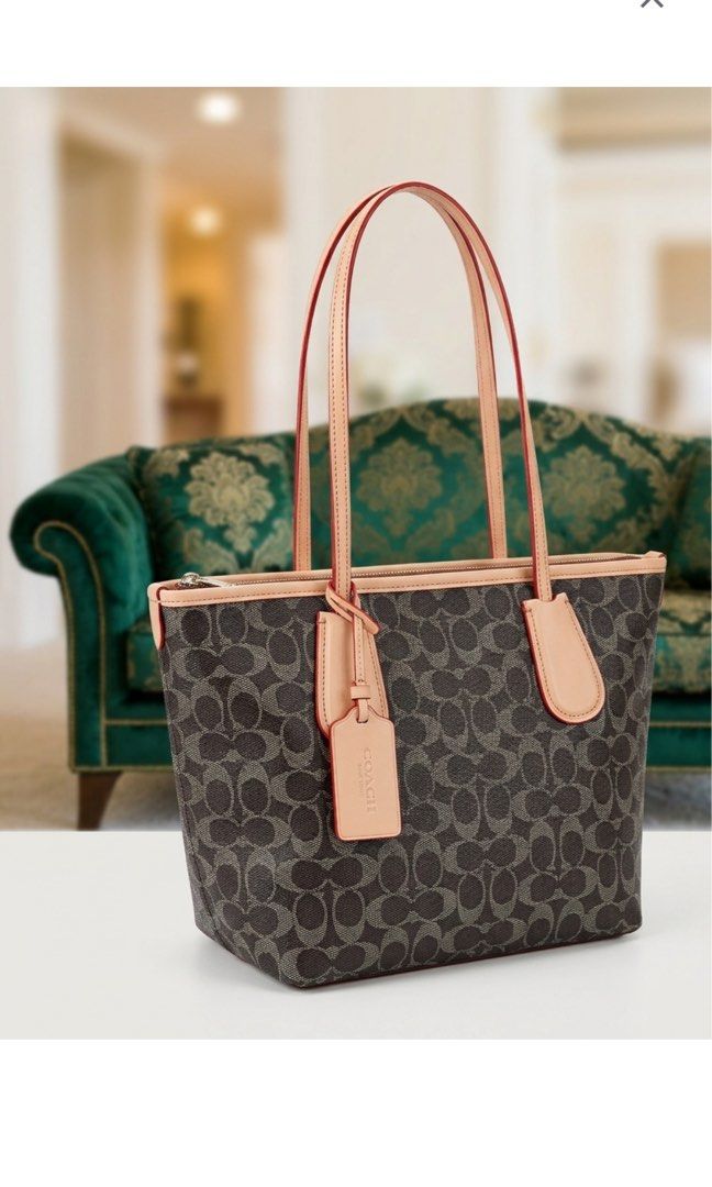 Authentic coach small city zip tote (Category: Tote Bags) located in Caloocan City. Submitted by trebdy01 (Listing ID 1469940923, Image 1). Description: 100% Authentic Coach Small City Zip Tote in Signature Canvas (Dark Brown / Vachetta Trim) Description: Selling an authentic Coach Small City Zip Tote Bag in classic dark brown signature coated canvas with smooth vachetta/tan leather trim. This is the perfect lightweight daily shoulder bag—not too