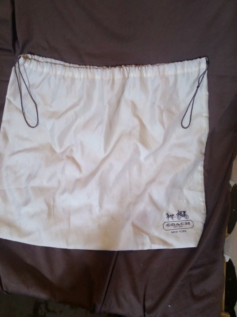 Authentic Coach White Dust Bag with Drawstring (Category: Luxury Bags & Wallets) located in Marikina City. Submitted by picker_seller17 (Listing ID 1469833245, Image 1). Description: - Authentic Coach dust bag - Color: White with dark brown drawstring - Features the classic Coach New York horse and carriage logo - Soft, high-quality fabric material - Protects luxury handbags from dust and scratches - Ideal for bag storage or replacement.