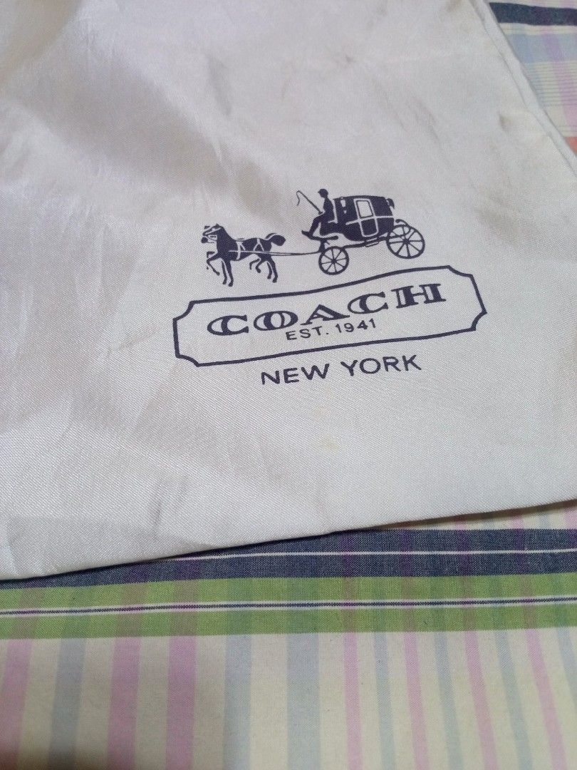 Authentic Coach White Dust Bag with Drawstring (Category: Luxury Bags & Wallets) located in Marikina City. Submitted by picker_seller17 (Listing ID 1469833245, Image 3). Description: - Authentic Coach dust bag - Color: White with dark brown drawstring - Features the classic Coach New York horse and carriage logo - Soft, high-quality fabric material - Protects luxury handbags from dust and scratches - Ideal for bag storage or replacement.