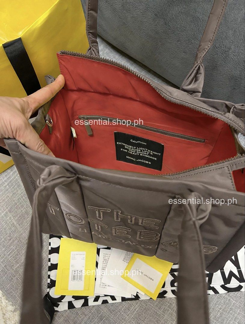 Authentic Marc Jacobs Medium Puffer Tote Cement (Category: Tote Bags) located in Manila. Submitted by essential.shop.ph (Listing ID 1469930683, Image 3). Description: FOR PRE-ORDER. 7-10 days ETA ☺️ Authentic Marc Jacobs Nylon Medium Puffer Tote Cement color Top zip closure Top handle 2 external side pockets 1 Interior Slip Pocket, 1 Interior Zip Pocket Polyester Lining Includes paper bag, dust bag, tag and care cards. Dimensions L 33cm x D 15cm 