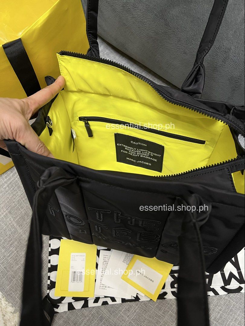 Authentic Marc Jacobs Medium Puffer Tote Black (Category: Tote Bags) located in Manila. Submitted by essential.shop.ph (Listing ID 1469931233, Image 3). Description: FOR PRE-ORDER. 7-10 days ETA ☺️ Authentic Marc Jacobs Nylon Medium Puffer Tote Cement color Top zip closure Top handle 2 external side pockets 1 Interior Slip Pocket, 1 Interior Zip Pocket Polyester Lining Includes paper bag, dust bag, tag and care cards. Dimensions L 33cm x D 15cm D