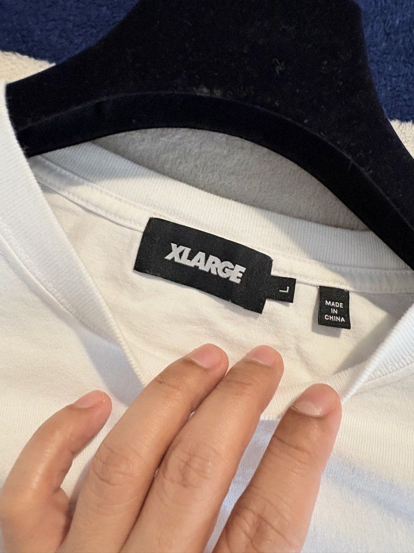 Authentic XLARGE Standard Reflectorized Logo Shirt (Category: Tshirts & Polo Shirts ) located in Mandaluyong City. Submitted by material_boi (Listing ID 1469797949, Image 3). Description: XLARGE is a cult classic streetwear. Store bought, not thrifted or something. Used once, launderer once. Tag says L: approx 21 inches wide and 28 inches long. 100% cotton. No issue. Perfect for hypebeast people. RFS: decluttering.