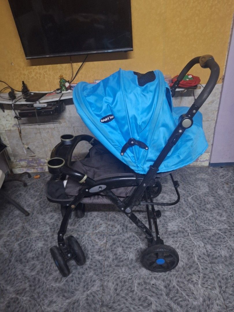 Baby 1st Stroller with Star Pattern Canopy (Category: Strollers) located in Manila. Submitted by 2lj_closet (Listing ID 1469872366, Image 1). Description: - Brand: Baby 1st Stroller - Color: Blue and grey with fun star pattern seat - Sun Protection: Protective hood with mesh peek-a-boo window - Convenience: Front snack tray with 2 built-in cup holders - Frame: Sturdy black frame with multi-wheel setup - Portability: Easily folds down for storage 