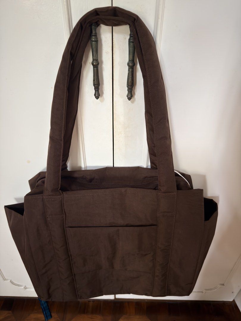 Baggu Cloud Tote Bag Coffee Brown (Category: Tote Bags) located in Muntinlupa City. Submitted by atol0987 (Listing ID 1469799444, Image 2). Description: - Brand: Baggu Cloud Tote - Color: Coffee Brown - Condition: Brand new with tag (BNWT), includes original Rustan's receipt - Material: Lightweight, durable nylon - Features: Secure zip top closure, dual shoulder straps, deep side slip pockets, and a spacious main compartment with an interior zipp