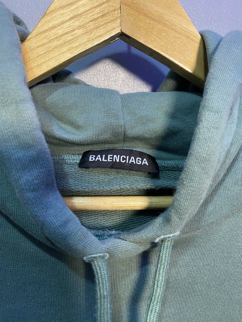 Balenciaga BB Mode Green Hoodie (Category: Hoodies) located in Caloocan City. Submitted by retrowear.gallery (Listing ID 1469777345, Image 3). Description: - Brand: Balenciaga - Color: Muted sage green - Design: Large BB logo graphic printed on the chest - Features: Drawstring hood, front kangaroo pocket, ribbed cuffs and hem - Origin: Made in Portugal - Condition/Details: Collar tag and interior wash labels attached - Perfect for elevated street
