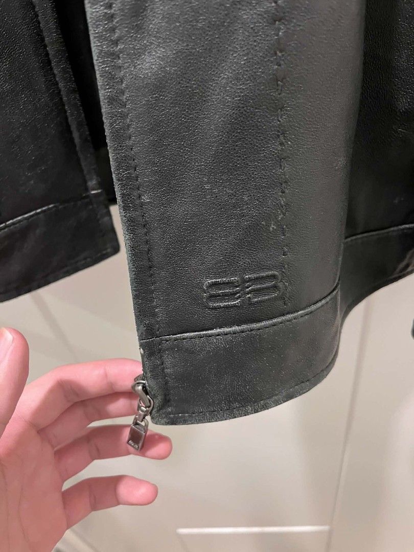 Balenciaga Black Leather Jacket vintage (Category: Coats, Jackets and Outerwear) located in Tuguegarao City. Submitted by ZeevLim (Listing ID 1469930102, Image 3). Description: - Brand: Balenciaga ( authentic/legit) - Color: Black - Material: Heavyweight leather with clean dark lining - Design: Structured collar, clean lines, classic cut, and subtle tonal stitching - Hardware: Custom zipper pull with iconic BB logo - Pockets: Functional front poc