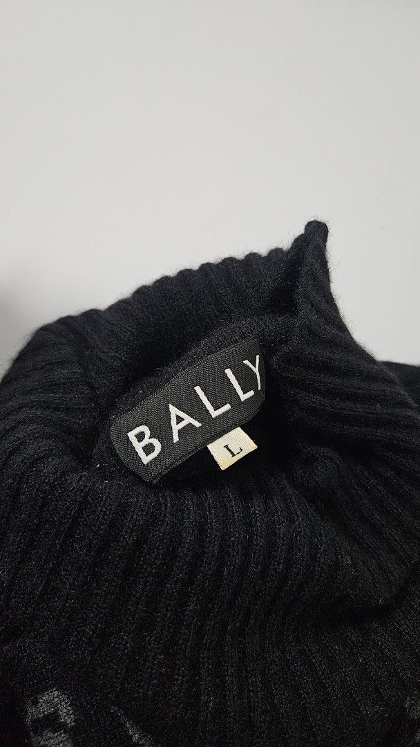 Bally Black Pattern Turtleneck Sweater (Category: Longsleeves) located in Alfonso. Submitted by jbcamet (Listing ID 1469861577, Image 2). Description: - Brand: Bally - Size: Large - Material: Warm wool blend - Design: Mixed animal print (leopard and tiger spots in brown/grey) on front panel - Details: Ribbed knit texture on sleeves and collar, turtleneck, Japanese care label - Condition: Ready for cooler weather.