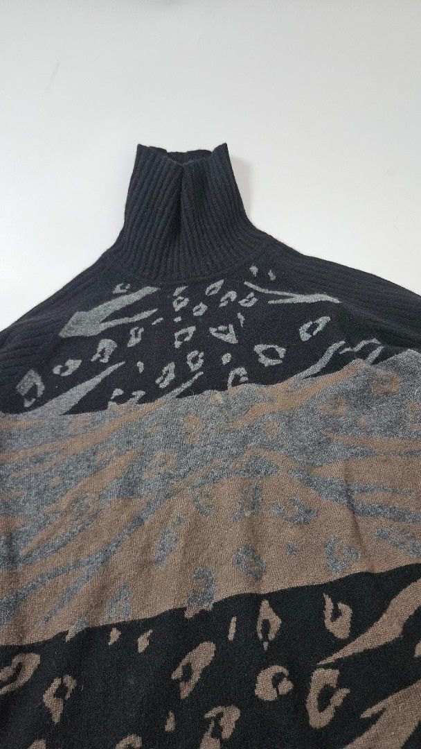 Bally Black Pattern Turtleneck Sweater (Category: Longsleeves) located in Alfonso. Submitted by jbcamet (Listing ID 1469861577, Image 3). Description: - Brand: Bally - Size: Large - Material: Warm wool blend - Design: Mixed animal print (leopard and tiger spots in brown/grey) on front panel - Details: Ribbed knit texture on sleeves and collar, turtleneck, Japanese care label - Condition: Ready for cooler weather.