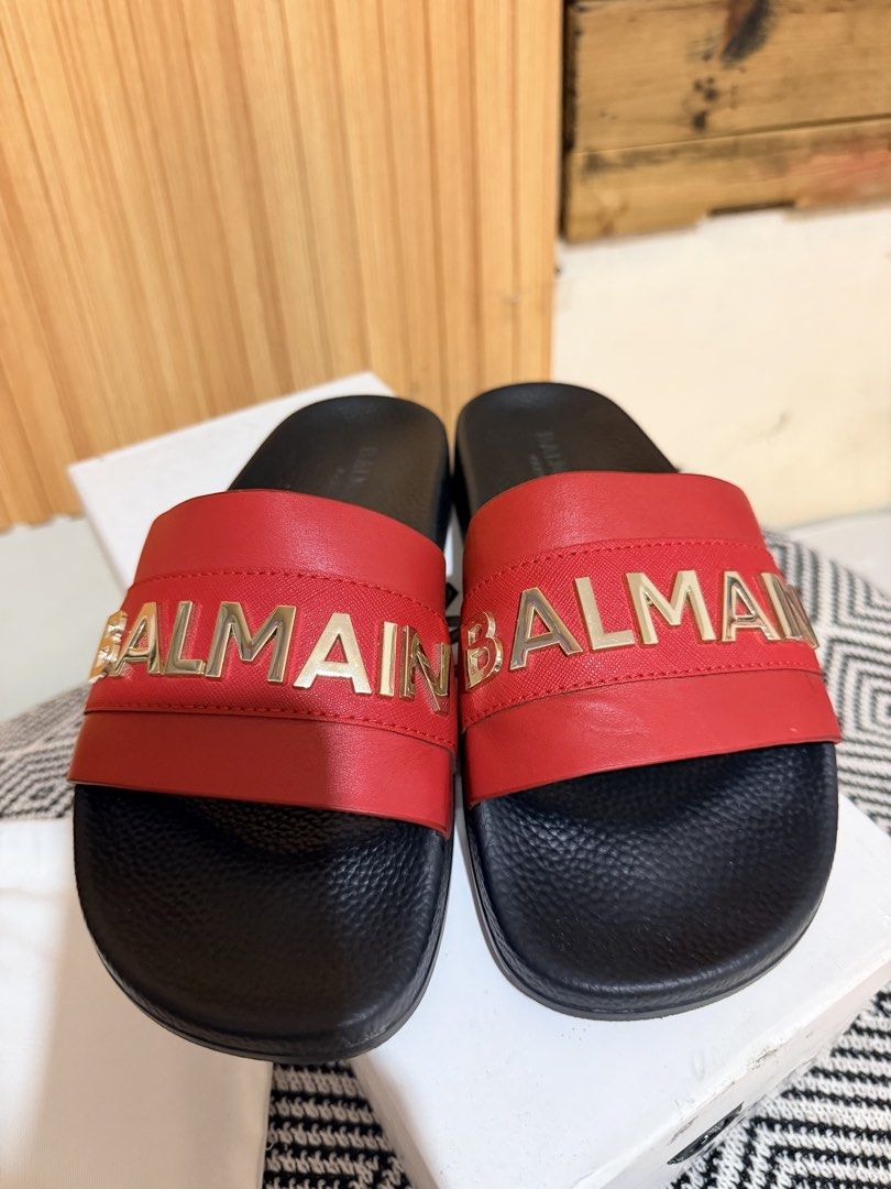 Balmain Paris Red Slides Sandals Size 37 with Box (Category: Flats & Sandals) located in Makati City. Submitted by ziagabrielle (Listing ID 1469765205, Image 2). Description: Balmain Paris slides in red and black. Gold tone logo lettering across the wide strap. Size 37. Includes original white dust bag and branded shoebox. Slip-on design with textured footbed. Grab these statement designer sandals for your footwear rotation. dustbag, box and pape