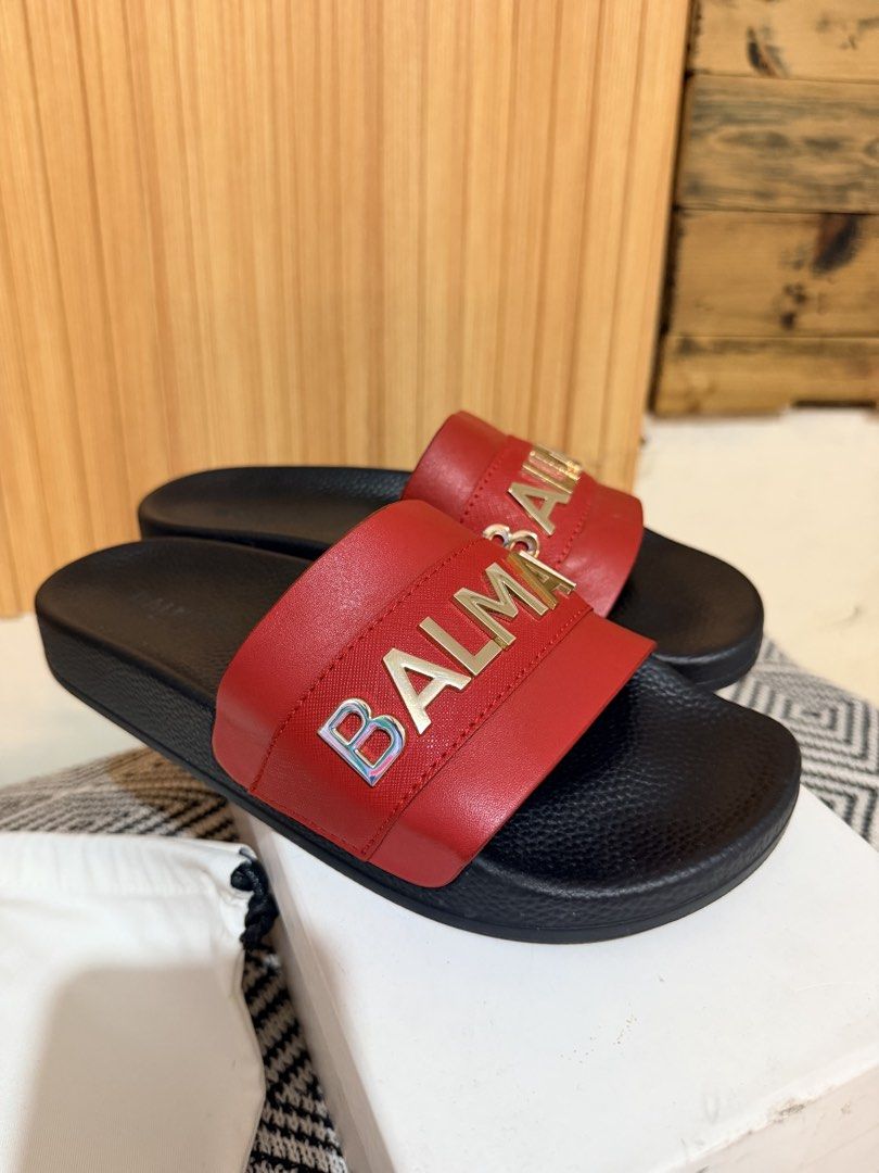 Balmain Paris Red Slides Sandals Size 37 with Box (Category: Flats & Sandals) located in Makati City. Submitted by ziagabrielle (Listing ID 1469765205, Image 3). Description: Balmain Paris slides in red and black. Gold tone logo lettering across the wide strap. Size 37. Includes original white dust bag and branded shoebox. Slip-on design with textured footbed. Grab these statement designer sandals for your footwear rotation. dustbag, box and pape