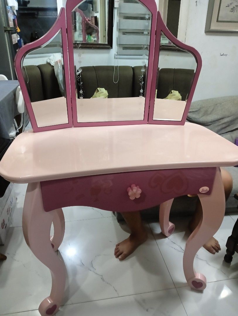 Barbie Kids Vanity Table with Tri-Fold Mirror (Category: Kids Toys) located in Manila. Submitted by josewendel71226 (Listing ID 1469890182, Image 1). Description: - Pink Barbie vanity table with tri-fold mirror - Features 1 pull-out drawer with a flower-shaped knob and elegant curved legs - Made of sturdy wood with a glossy finish - Includes original product safety and warranty sticker on the back - Condition: Noticeable peeling and chipping on t