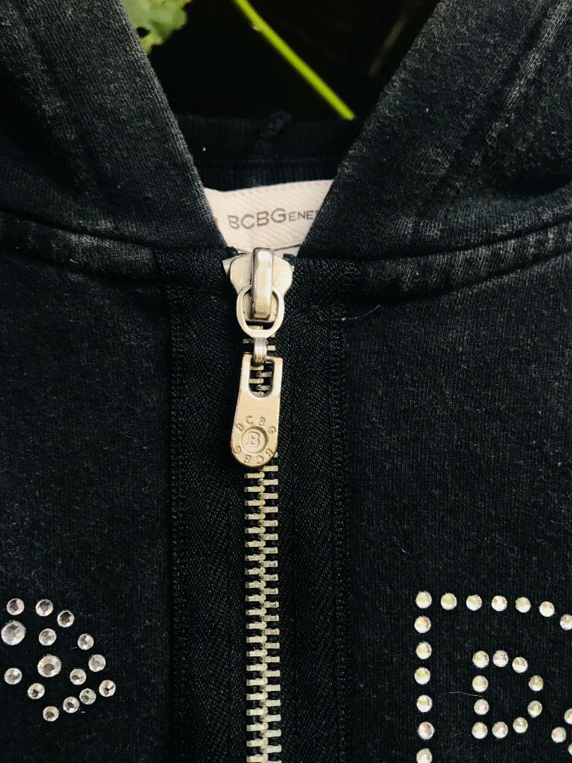 BCBGeneration Rhinestone Black Zip-Up Hoodie (Category: Coats, Jackets and Outerwear) located in Camiling. Submitted by akosiano (Listing ID 1469840409, Image 3). Description: - Brand: BCBGeneration - Style: Zip-up hoodie with classic Y2K rhinestone logo and zipper strip - Size: Medium - Features: Front pockets, branded metal pull - Origin: Made in Indonesia - Condition: Great casual wear.