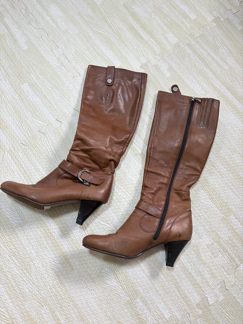 Belle Classical Series Brown Knee-High Boots Size 245 (Category: Boots) located in Quezon City. Submitted by marifavo (Listing ID 1469825142, Image 1). Description: - Brand: BeLLA Classical Series - Color: Rich brown - Size: 245 - Style: Knee-high boots with mid-length heel and subtle ankle buckle strap - Closure: Convenient side zipper - Condition: Clean soles with visible size branding - Perfect for: Versatile everyday autumn and winter outfits