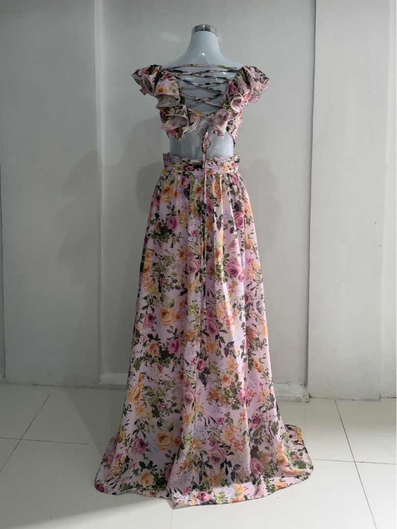 Belle Floral Flutter Sleeve Backless Ruffle Maxi Dress (Category: Dresses) located in Mandaluyong City. Submitted by jaimierouu (Listing ID 1469838835, Image 3). Description: - Style: Pink pastel floral maxi dress - Material: Lightweight, breezy chiffon - Details: Deep V-neckline with ruffle cap sleeves - Fit: Crossover straps with trendy side cutouts - Back: Adjustable lace-up closure - Length: Floor-length, flowy A-line skirt - Condition: Excel
