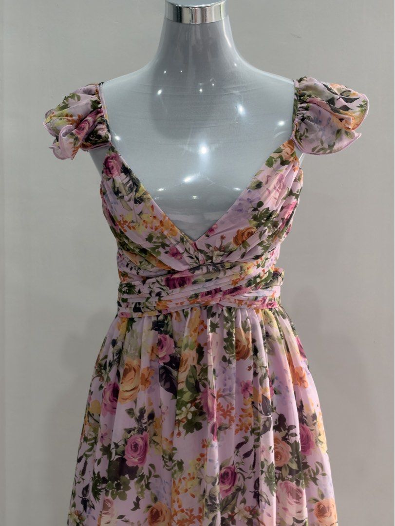 Belle Floral Flutter Sleeve Backless Ruffle Maxi Dress (Category: Dresses) located in Mandaluyong City. Submitted by jaimierouu (Listing ID 1469838835, Image 2). Description: - Style: Pink pastel floral maxi dress - Material: Lightweight, breezy chiffon - Details: Deep V-neckline with ruffle cap sleeves - Fit: Crossover straps with trendy side cutouts - Back: Adjustable lace-up closure - Length: Floor-length, flowy A-line skirt - Condition: Excel