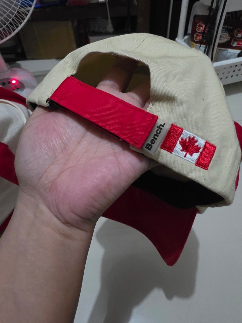 Bench Canada Heritage Two-Tone Baseball Cap (Cream/Red) (Category: Caps & Hats) located in Calamba. Submitted by stuffsbysaz (Listing ID 1469910688, Image 3). Description: Size: OSFM (One Size Fits Most) - Adjustable via fabric strap closure Product Details: • Brand: Bench (Official Bench Canada merchandise) • Design: Two-tone aesthetic featuring a cream-colored crown panel paired with a vibrant red flat brim/visor. • Front Details: High-quality,