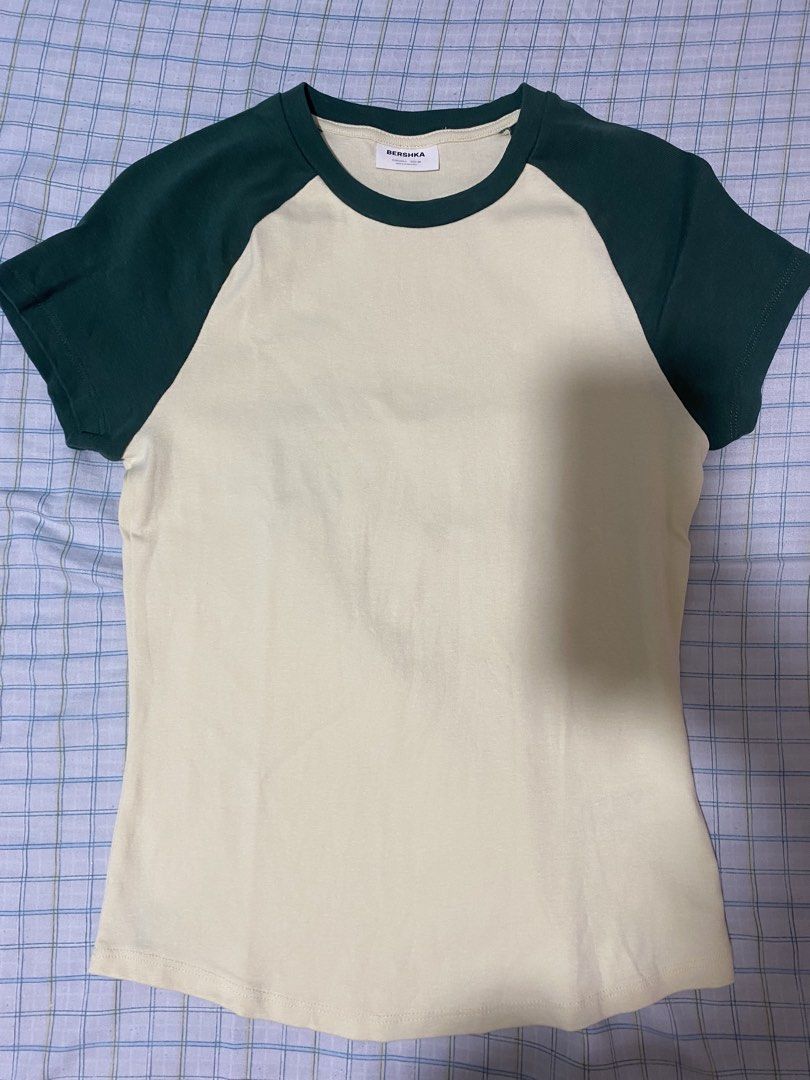 Bershka Green and Cream Ringer Tee (Category: Shirts) located in Manila. Submitted by vickim0513 (Listing ID 1469938133, Image 1). Description: - Brand: Bershka - Style: Retro ringer t-shirt with ribbed neckline - Color: Cream with dark green contrast short sleeves - Size: EUR/USA L, MEX 30 - Material: Comfortable cotton blend - Made in: Bangladesh - Condition: Great casual everyday piece, easy to pair with denim or shorts - Used only once.