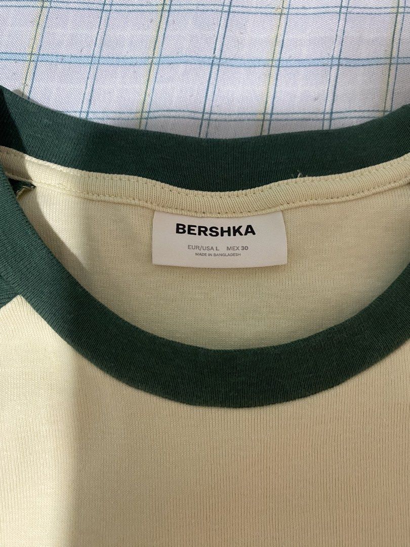 Bershka Green and Cream Ringer Tee (Category: Shirts) located in Manila. Submitted by vickim0513 (Listing ID 1469938133, Image 2). Description: - Brand: Bershka - Style: Retro ringer t-shirt with ribbed neckline - Color: Cream with dark green contrast short sleeves - Size: EUR/USA L, MEX 30 - Material: Comfortable cotton blend - Made in: Bangladesh - Condition: Great casual everyday piece, easy to pair with denim or shorts - Used only once.