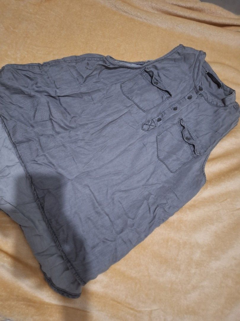 Bershka Grey Sleeveless Button-Up Top Size M (Category: Sleeveless) located in Paranaque City. Submitted by ellech16 (Listing ID 1469832747, Image 1). Description: - Brand: Bershka - Size: M (Mex 38, USA M) - Color: Grey - Material: Lightweight denim-style fabric - Features: Dual chest pockets, button placket, curved high-low hem - Condition: Excellent, pre-loved - Style: Casual and easy to pair with jeans or shorts.