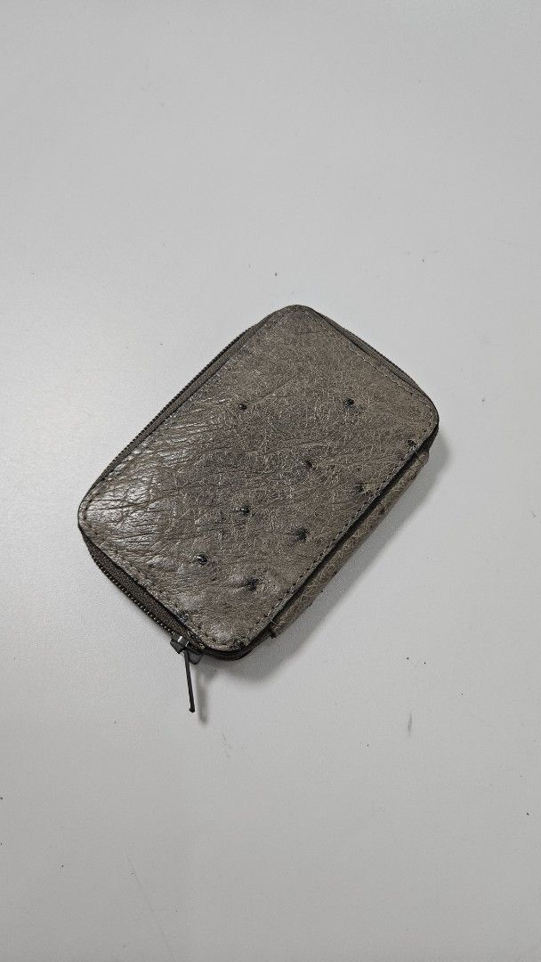 Beverly Ostrich Leather Key Case (Category: Wallets & Card holders) located in Alfonso. Submitted by jbcamet (Listing ID 1469860700, Image 2). Description: Genuine ostrich leather key case by Beverly. Grey exterior with quill texture. Zip-around closure keeps keys secure. Inside has a golden 6-hook key holder and slip pocket. Original ostrich tag still attached. Interior lining shows minor storage marks near the brand plaque. Compact size for dai