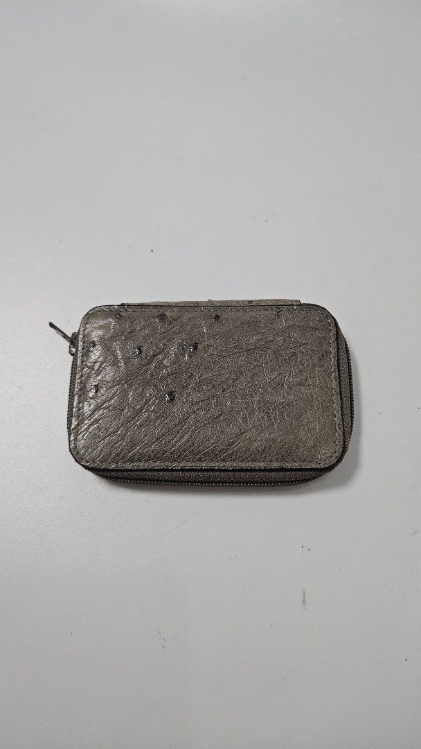 Beverly Ostrich Leather Key Case (Category: Wallets & Card holders) located in Alfonso. Submitted by jbcamet (Listing ID 1469860700, Image 1). Description: Genuine ostrich leather key case by Beverly. Grey exterior with quill texture. Zip-around closure keeps keys secure. Inside has a golden 6-hook key holder and slip pocket. Original ostrich tag still attached. Interior lining shows minor storage marks near the brand plaque. Compact size for dai